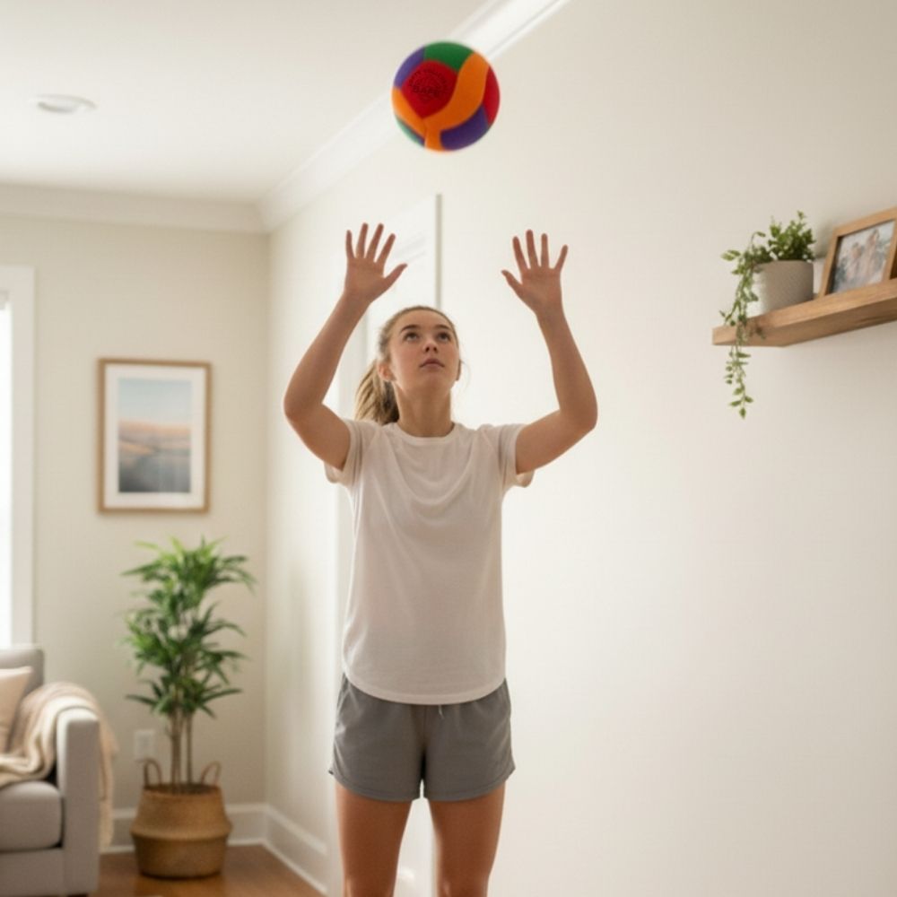 Person playing with a colorful ball in a living room