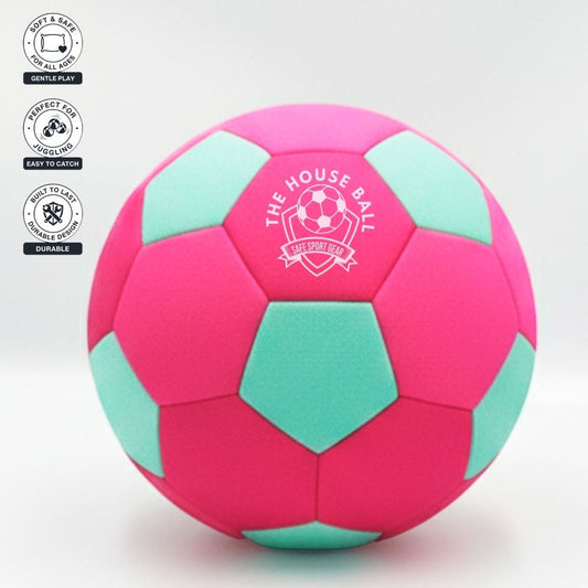 Pink and green soccer ball with 'The House Ball' logo on a white background