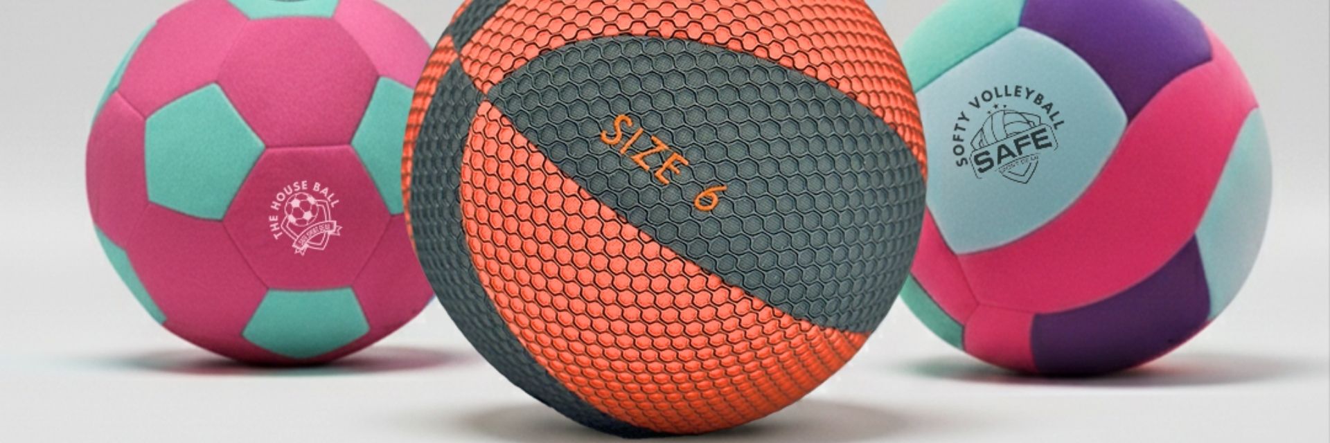 Three colorful sport balls on a light gray background