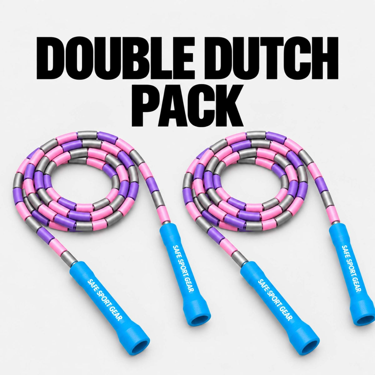 Two pink and purple jump ropes with blue handles and silver metal accents, arranged side by side on a light gray background with the text 'DOUBLE DUTCH PACK' at the top. The handles are branded with 'SAFE SPORT GEAR'.