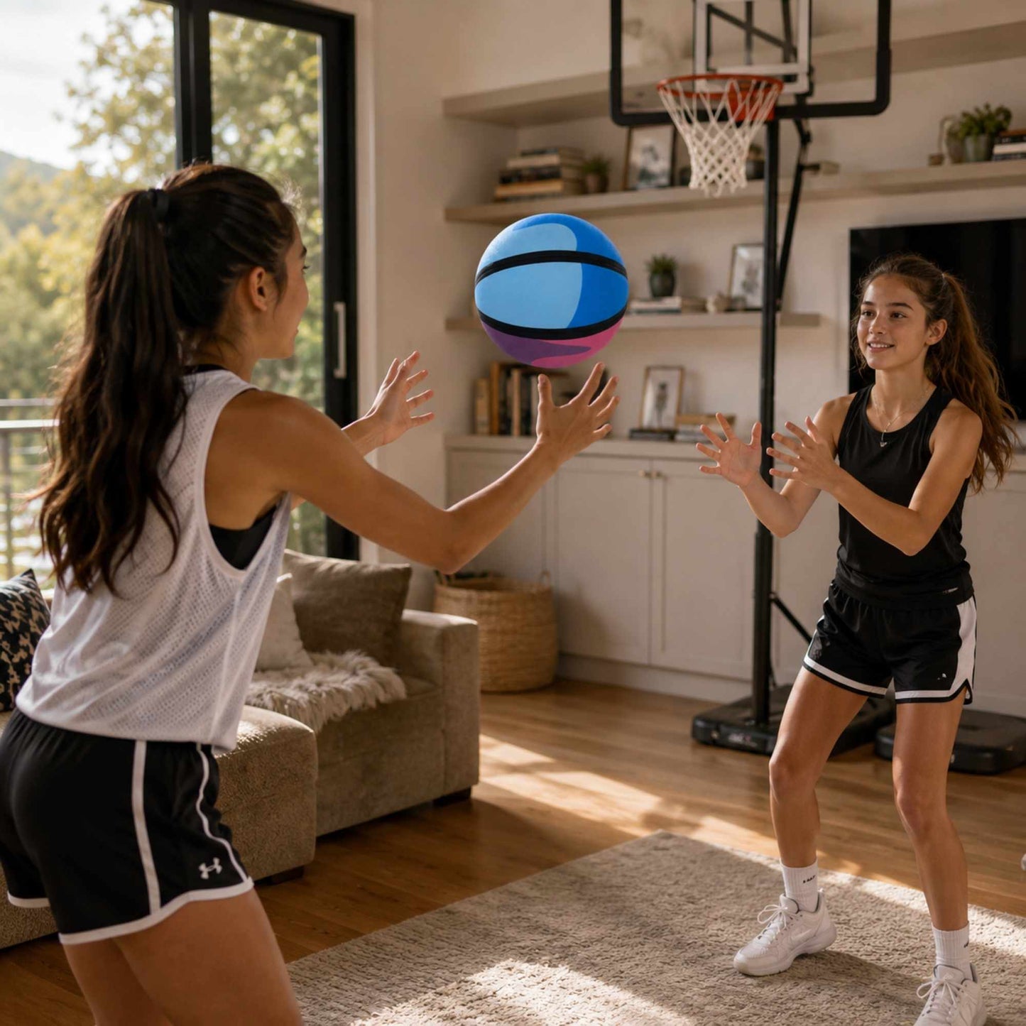 Two young women playing HouseHoops basketball - Soft Handles in a living room.