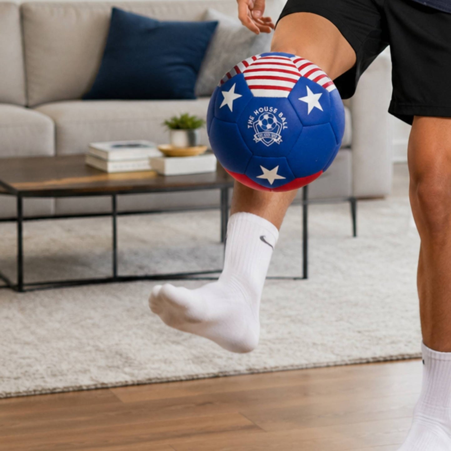 Person kicking a House Ball - USA with white stars in a living room.