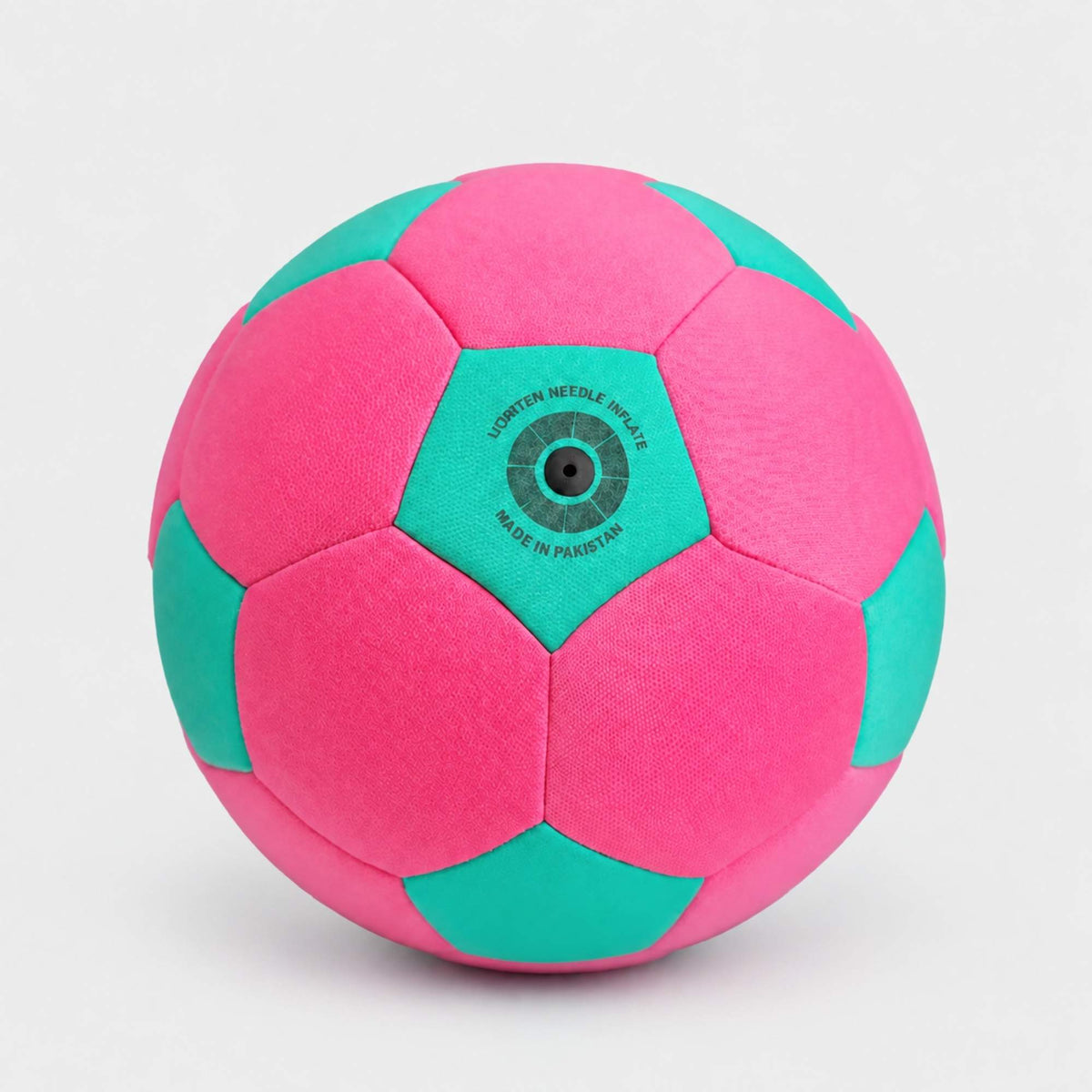 A pink and teal soccer ball with a central hexagonal patch photographed on a light gray background.