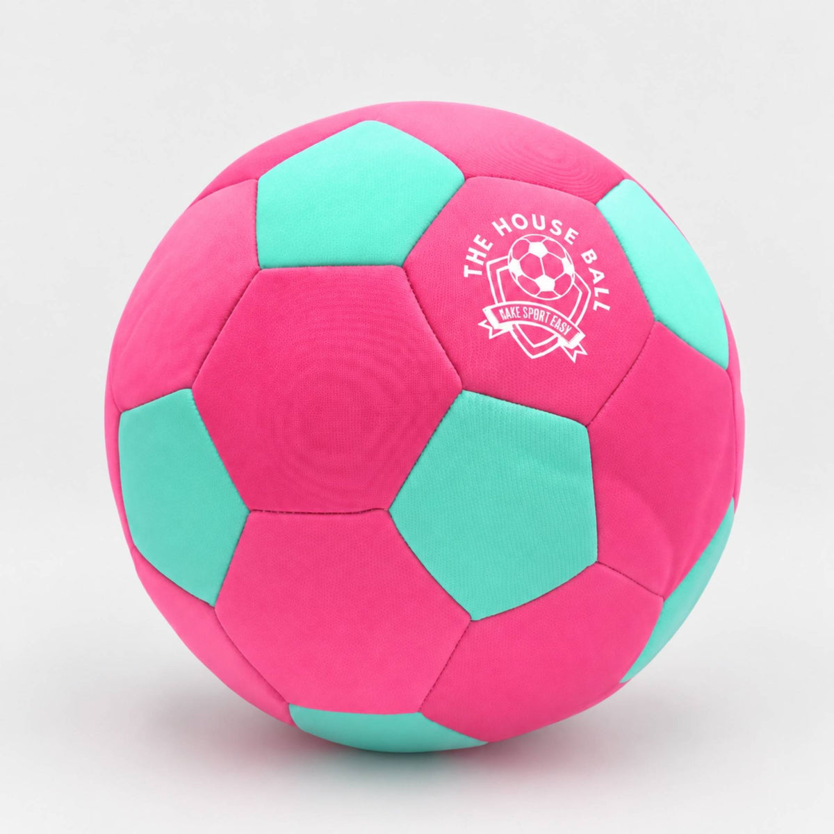A pink and mint green house ball with a white printed logo that reads 'THE HOUSE BALL' and 'Safe Sport Gear' on a light gray background.