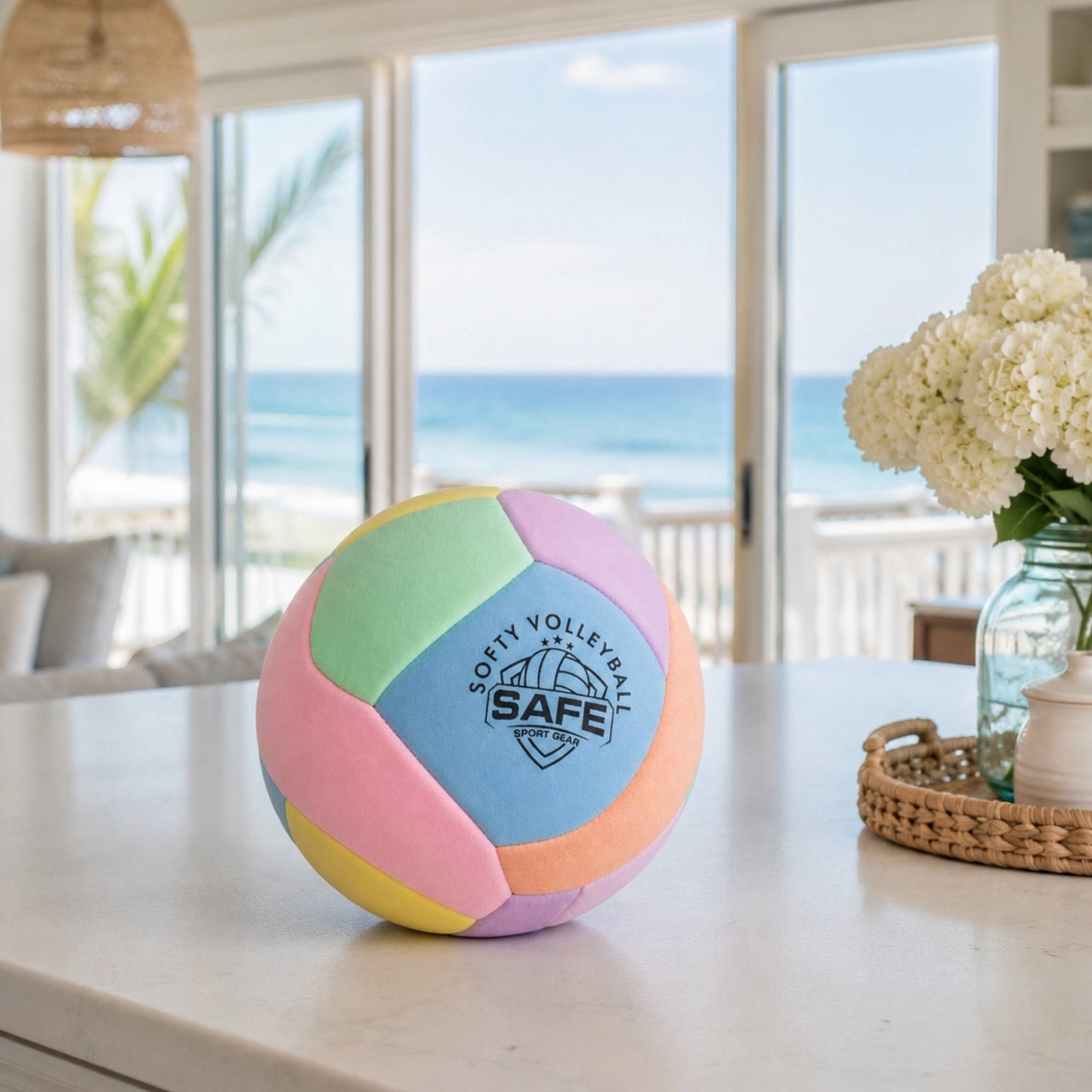 Softy Volleyball - Pink on a table with a beach view in the background